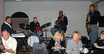 The foursome of Lambazz.with ome fans sitting at the foot of the stage.